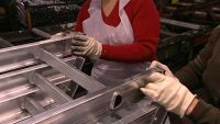 FINALLY, WORKERS RIVET RUBBER PADS