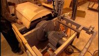 MEANWHILE, ANOTHER WORKER ASSEMBLES