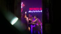 (Music and chatter inside bar)
