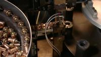 THE COMPONENTS NOW ENTER A MACHINE