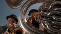 [trumpet playing]
