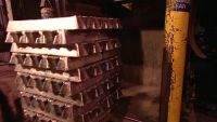 WORKERS LOAD ALUMINUM INGOTS