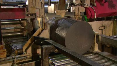 A BAND SAW
CUTS THE COOLED INGOTS - How It's Made