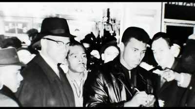 A crowd, hundreds of people,
surrounding them. - Blood Brothers: Malcolm X and Muhammad Ali