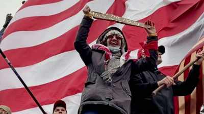 A photo
shows Hernandez holding up - The Insurrectionist Next Door