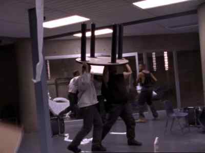 [alarm blaring]
[inmates yelling] - Oz