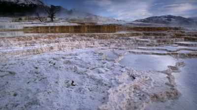 Algae in the warm pools
turn the stone shelves - Yellowstone: One-Fifty