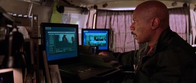 Ambrose is showing something to mccloy on a digital camera - Mission: Impossible II