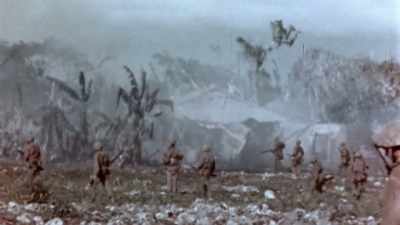 ANOTHER COMPANY GETS
HUNG UP IN A VILLAGE, - The Pacific War in Color