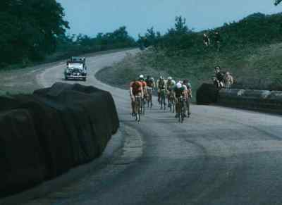 Another downhill stretch,
and here's a newcomer in the lead. - XIVth Olympiad: The Glory of Sport