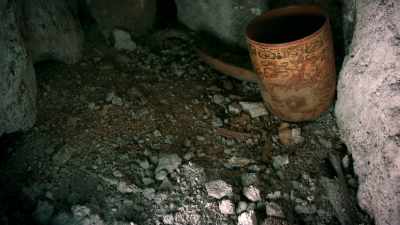 Around the ceramic cup,
badly decayed bones, - Lost Treasures of the Maya