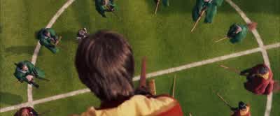 ...as Madam Hooch steps ontothe field to begin the game! - Harry Potter and the Philosopher's Stone