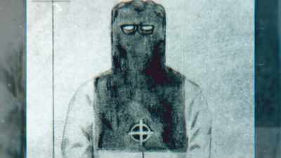 Beeson: This black ceremonial-type
hood has a logo on it, - Myth of the Zodiac Killer