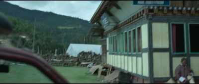 [Bhutanese pop music playing on radio] - The Monk and the Gun