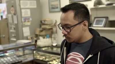 ‐ Brad examines the first coin - Lost Gold of World War II