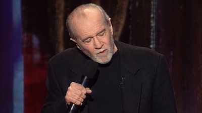 -But he loves you.
-(AUDIENCE LAUGHING) - George Carlin's American Dream