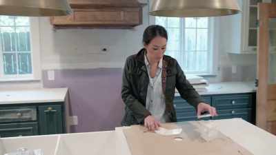Chip's laying the octagon
marble I picked out - Fixer Upper: Behind the Design
