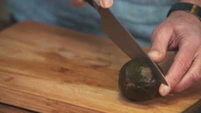 Chopping it in half,
using your very sharp knife. - James May: Oh Cook!