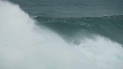 Chunky, windy storm surf. - Edge of the Earth