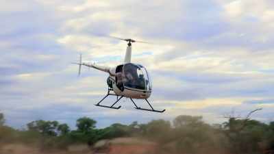 Col's gamble on hiring
Stoney and his helicopter - Outback Opal Hunters