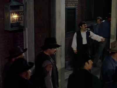 Come on, boys, break 'er down! Get in there! - The Return of Frank James