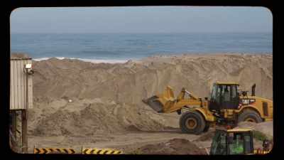Digging up the beach,
pushing the sea wall back, - Edge of the Earth