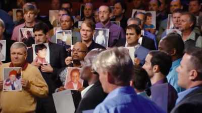 Each one is holding
a picture of themselves - The Menendez Brothers