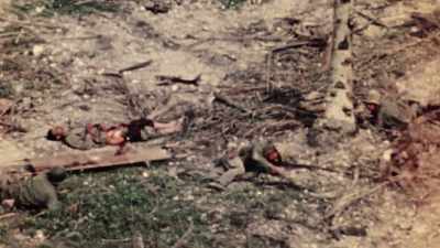 Enemy fire pins down two
corpsmen just yards away. - The Pacific War in Color