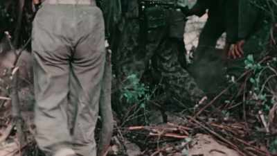 EVEN AS TROOPS TRY TO LURE
THEM OUT WITH A HELPING HAND, - The Pacific War in Color
