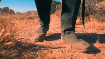 (feet shuffle)
(somber music continues) - Over The Red River