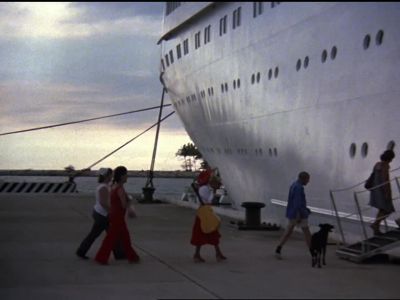 Female sailor: (On loudspeaker)
Attention all passengers. - The Love Boat