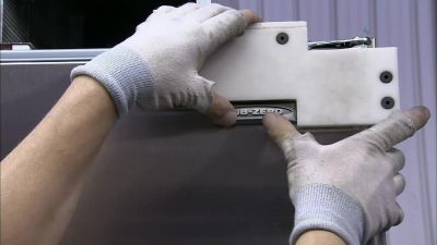 FINALLY, AN ADHESIVE LOGO
GOES ONTO THE DOOR. - How It's Made