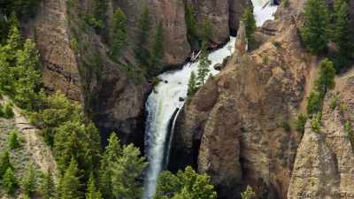 Flanked on either side by
eroded pillars of volcanic rock. - Yellowstone: One-Fifty