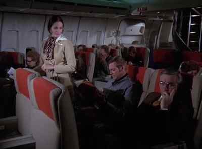 FLIGHT ATTENDANT:
May I have your attention, please? - The Six Million Dollar Man