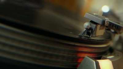 GEORGE: (OVER RECORD PLAYER)
My job essentially is - George Carlin's American Dream