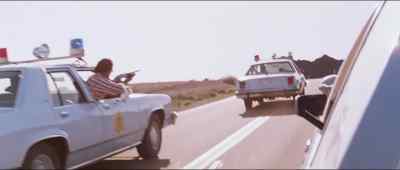 Get the gun! Use it! - The Hitcher