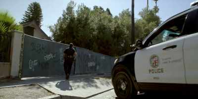 Guy wearing a red and black mask
running down this alley - Bosch: Legacy