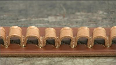 HE GLUES ON A LEATHER LINING
TO MAKE THE BELT MORE DURABLE. - How It's Made