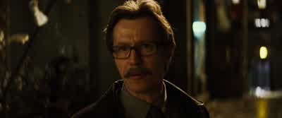 He is in a vehicleMake and colorIt's a blacktank - Batman Begins