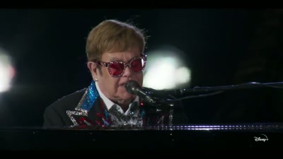♪ He makes a lot, they say ♪ - Elton John Live: Farewell from Dodger Stadium