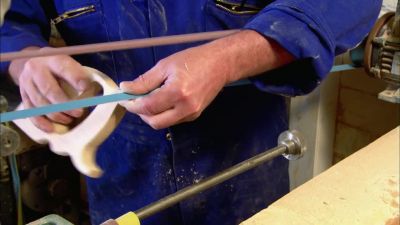 He sands the edges of the handle
until it's smooth. - How It's Made