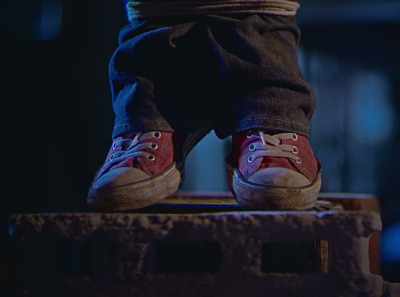He is standing on a few blocks of cement. - Leonor Will Never Die