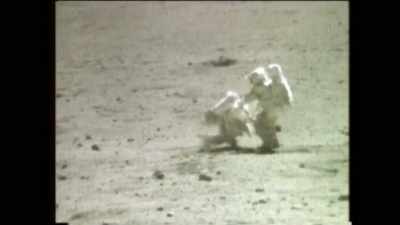 Here, the fallen astronaut
rises from the ground, - American Moon