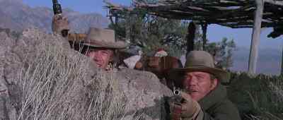 Hold your fire.
They're way up in those rocks. - Joe Kidd