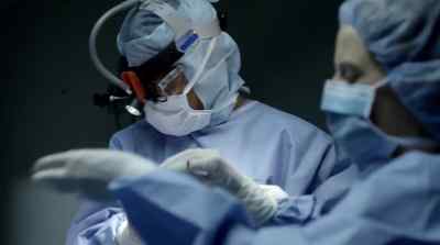 Holding skull flap
for reconstruction. - Gifted Hands: The Ben Carson Story