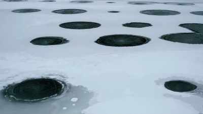 Holes in the frozen
surface mark spots - Yellowstone: One-Fifty