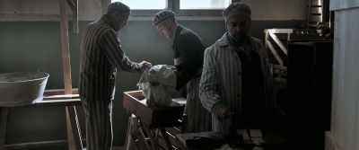 Hurry, load the storage
boxes into the truck! - The Photographer of Mauthausen