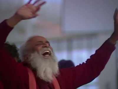 I approached Deva Raj
and said something into his ear. - Wild Wild Country