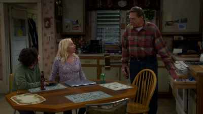 It's a man opening a drawer
with a bible - The Conners