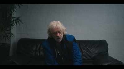 Jim wagging a finger - - Simple Minds: Everything is Possible